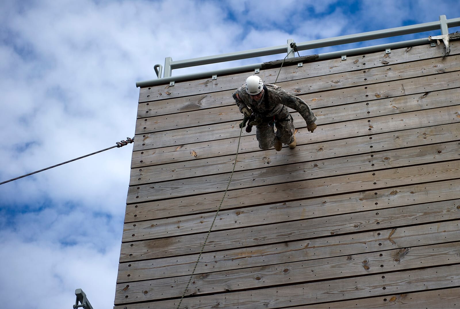 Soldier from the 7th Special Forces Group descending a rappel tower during training