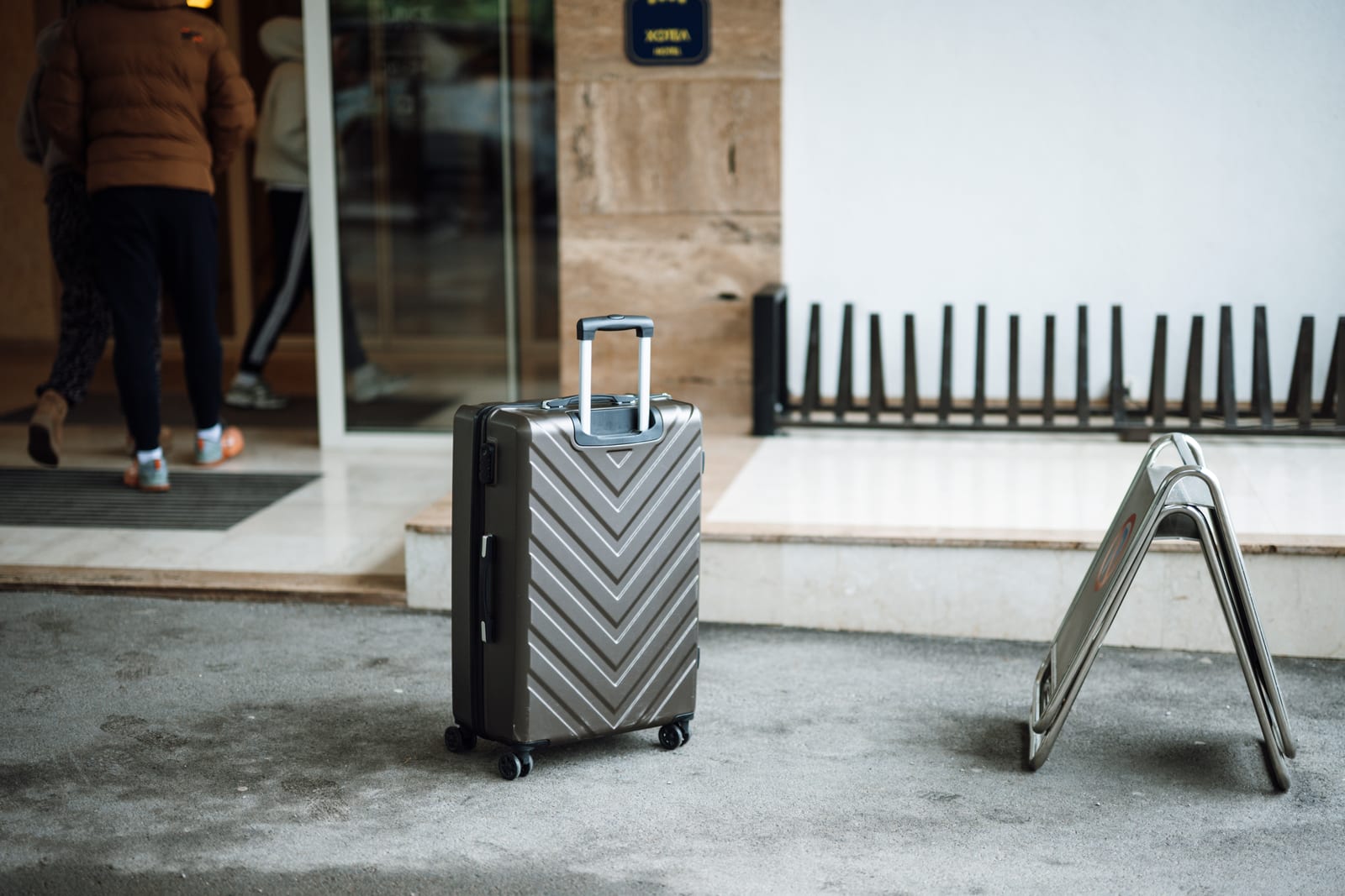 Suitcase waiting outside a hotel entrance during a military travel stay