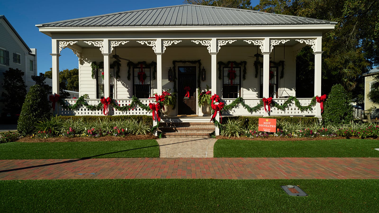 A restored historic Pensacola cottage with a wide porch and gingerbread trim