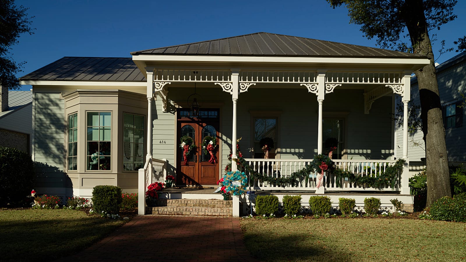 A restored historic cottage with a covered front porch in Pensacola, Florida