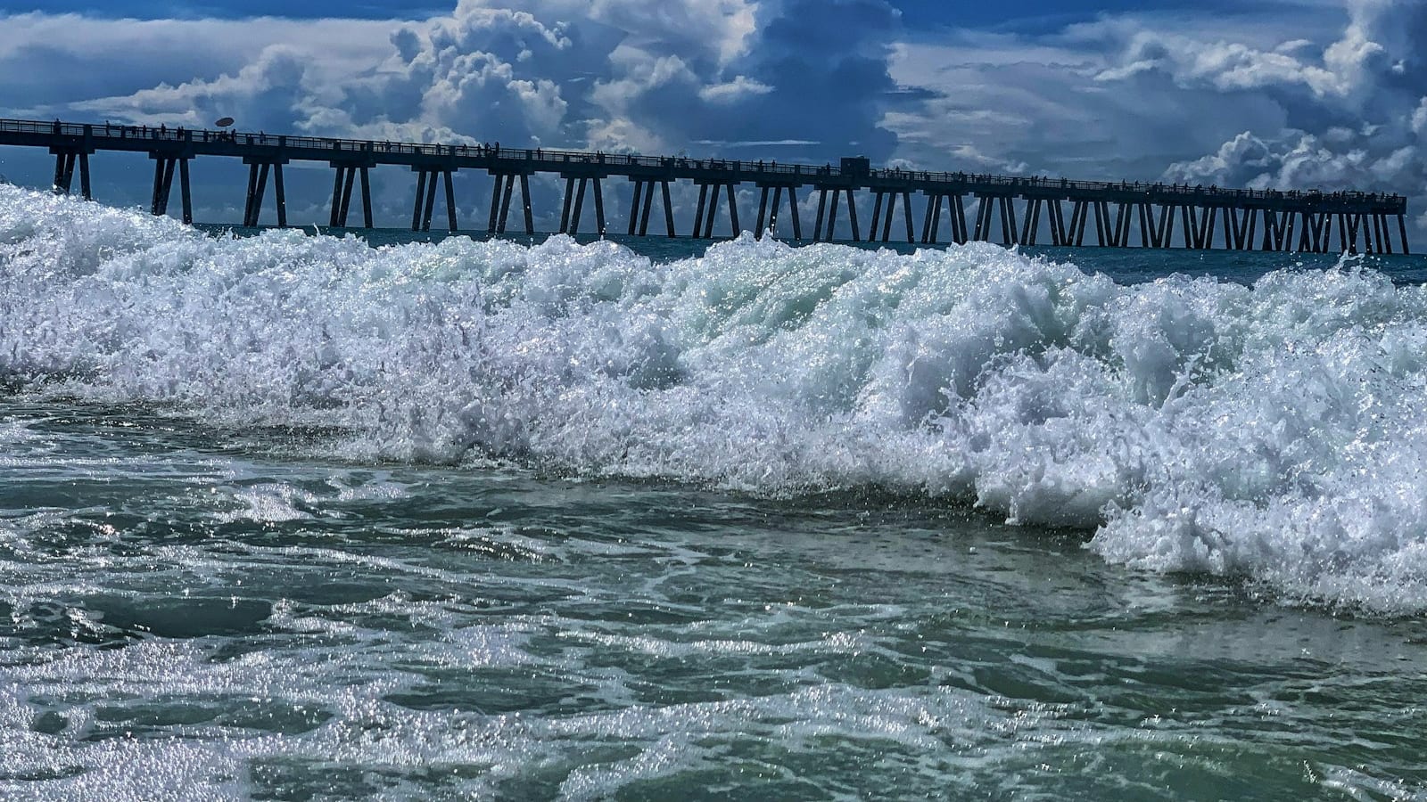 The Navarre Beach Fishing Pier extending into the emerald Gulf of Mexico