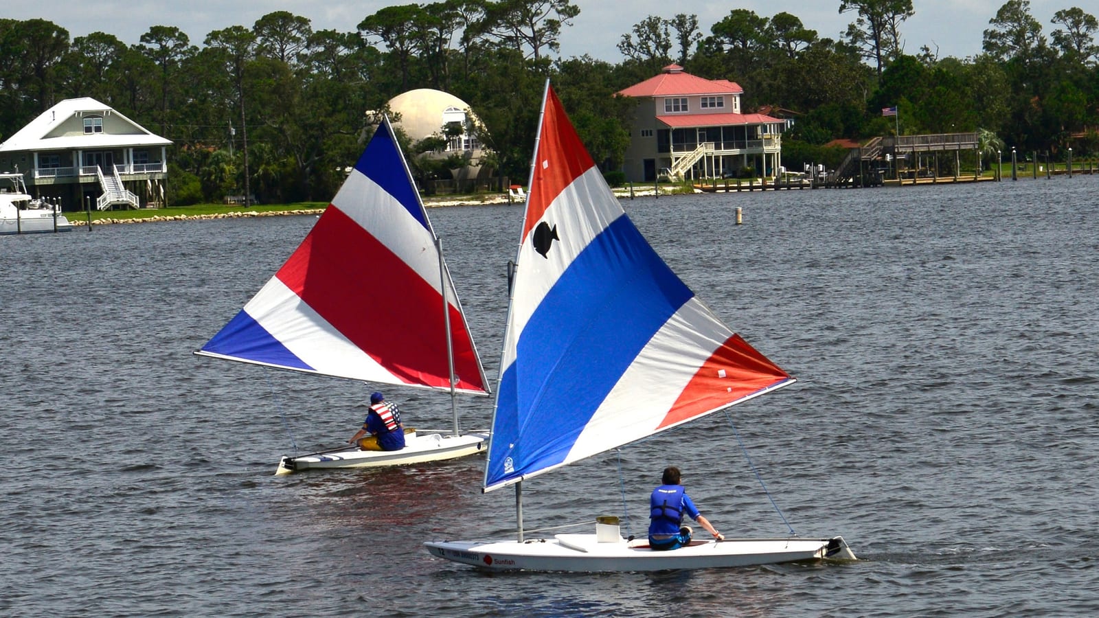 Sailboats on Bayou Grande with Navy Point waterfront homes near NAS Pensacola