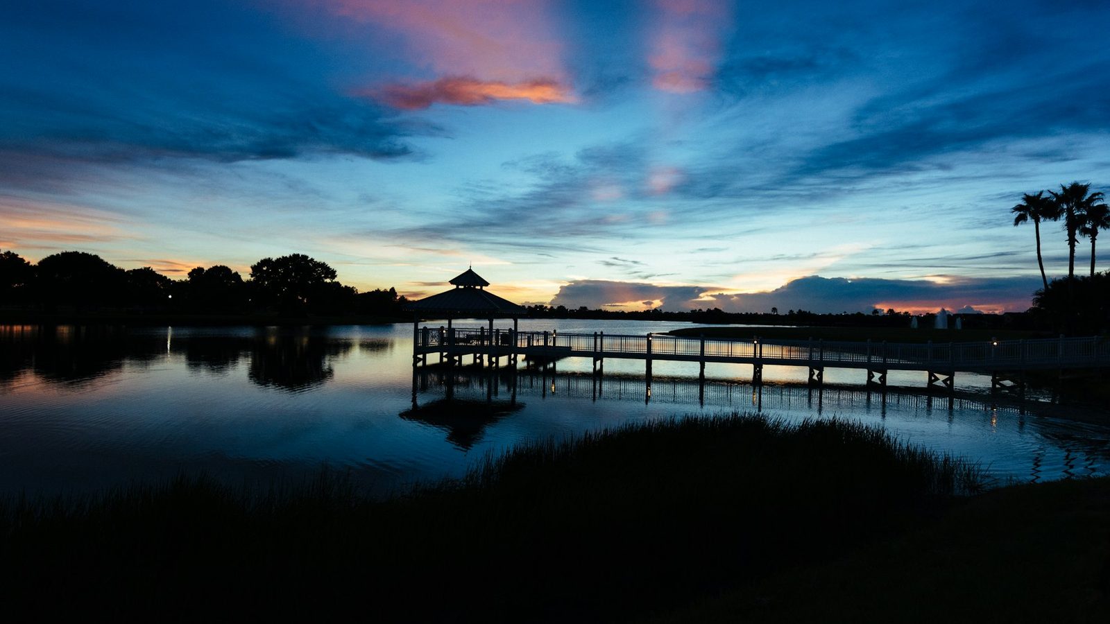 A bayfront boardwalk and gazebo at dusk, characteristic of Shalimar waterfront living