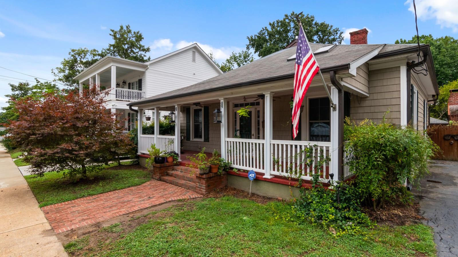 Florida bungalow with a front porch and American flag